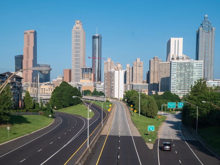 Downtown Atlanta skyscrapers rising beyond Freedom Parkway, seen from the Jackson Street Bridge on a clear day
