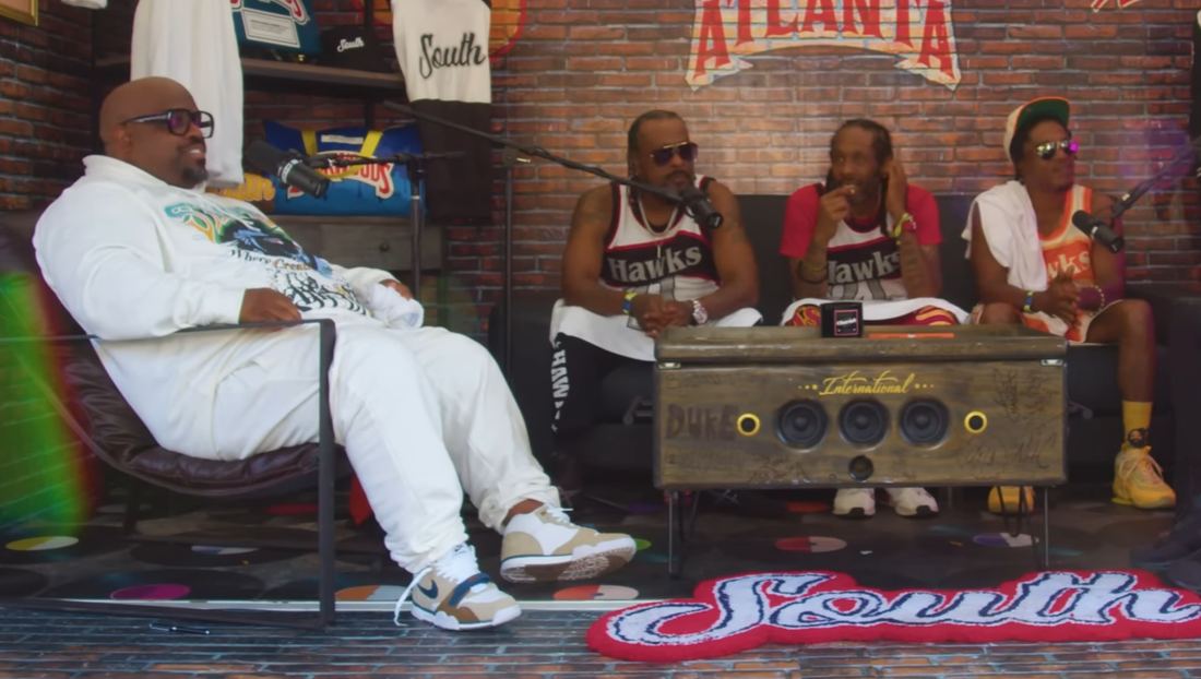 The members of Goodie Mob seated on a talk show set at an Atlanta music festival